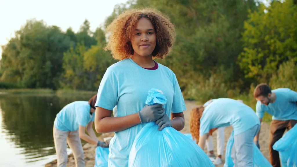 Portrait of youth volunteering on a beach cleaning.