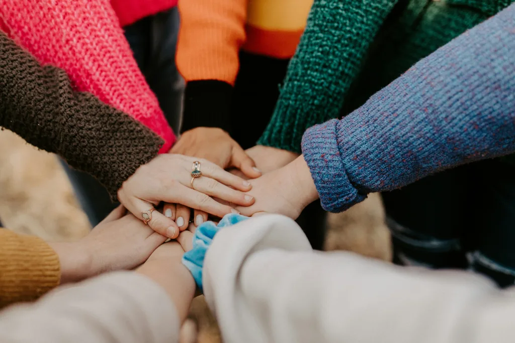 Girl friends hands piled together.